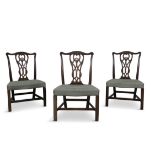 A SET OF THREE GEORGE III MAHOGANY DINING CHAIRS, each rectangular back with pierced interlaced