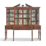 AN IRISH GEORGE III FOUR DOOR BREAKFRONT BOOKCASE, surmounted with pierced architectural pediment