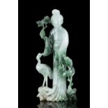 AN APPLE GREEN AND EMERALD ACCENTS JADEITE JADE ‘MEIREN AND CRANE’ GROUP China, 20th century,