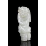 A JADE CARVING OF A BOY WITH A LOTUS SPRIG China, Qing Dynasty, 19th century The boy is holding