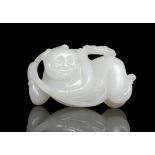 A ‘BOY AND LINGZHI’ WHITE JADE CARVING China, Attributed to Qing Dynasty The jade figure is