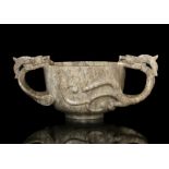 A CHICKEN BONE JADE ‘CHI DRAGONS’ TWO-HANDLED CUP China, Yuan to Ming Dynasty The cup is flanked