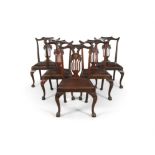 A SET OF SIX MAHOGANY FRAMED DINING CHAIRS, in the mid Georgian taste, with wave carved crest rail