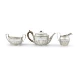 A VICTORIAN THREE PIECE SILVER TEASET, London, 1889, mark of Dobson & Sons, of oval form with
