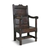 A CHARLES II OAK AND ELMWOOD WAINSCOT CHAIR, 17th Century with flat panelled back and arched top