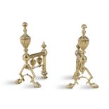 A PAIR OF EDWARDIAN AND POLISHED BRASS FIRE DOGS, c.1900, each with fluted baluster finials on