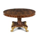 A FINE REGENCY ROSEWOOD AND PARCEL GILT TILT-TOP BREAKFAST TABLE, of circular form,