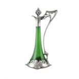 AN ART NOUVEAU GREEN GLASS CLARET JUG AND STOPPER with silvered stopper and angled handle with a