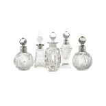 A COLLECTION OF VICTORIAN CUT GLASS SCENT BOTTLES WITH SILVER COLLARS (5)