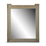 A SHAPED RECTANGULAR PAINTED MIRROR, the rectangular bevelled plate enclosed within a series of