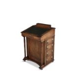 A MAHOGANY SLOPEFRONT DAVENPORT, with tooled leather inset and raised pen compartment,