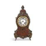 A FRENCH MANTEL CLOCK IN A RED BOULLE CASE, c.1900, with gilt metal mounts. 32cm high