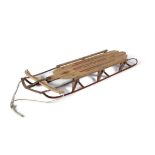 A 1930S AMERICAN 'SPEEDAWAY' SLEIGH, the timber slats laid on a brass frame. 140 x 55cm