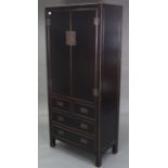 A Chinese style black & gold lacquered wardrobe, enclosed by pair of panel doors above two short &