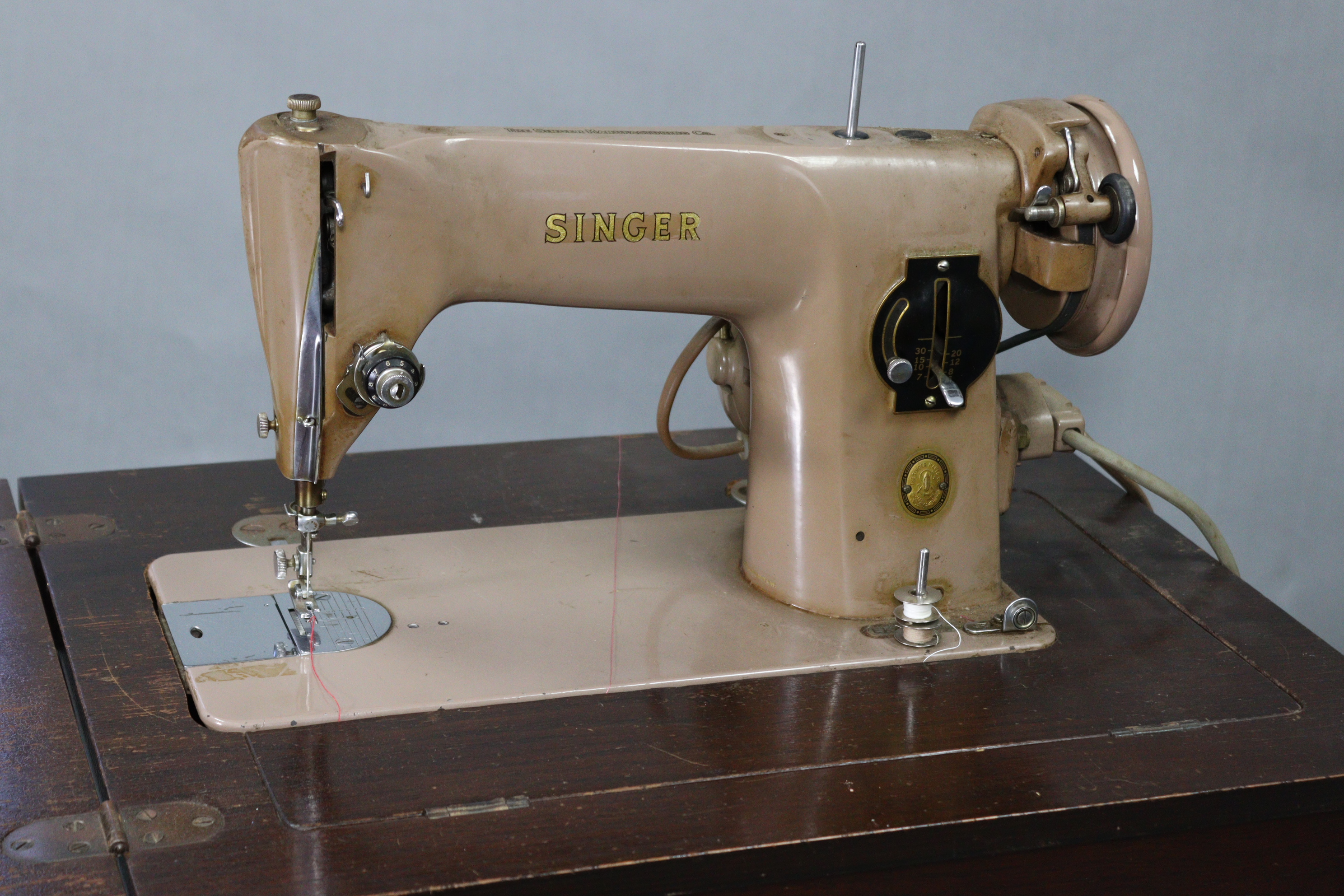 A Singer electric-operated sewing machine, w.o. in oak cabinet on four square tapered legs, “ wide. - Image 2 of 7