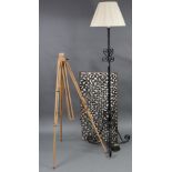 A black-finish wrought-metal standard lamp with shade; together with a coffee table top; & a