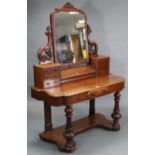 A Victorian mahogany “duchesse” dressing table, with rectangular swing mirror to the stage back,