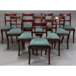 A set of ten regency-style mahogany bow-back dining chairs with padded drop-in seats, & on fluted