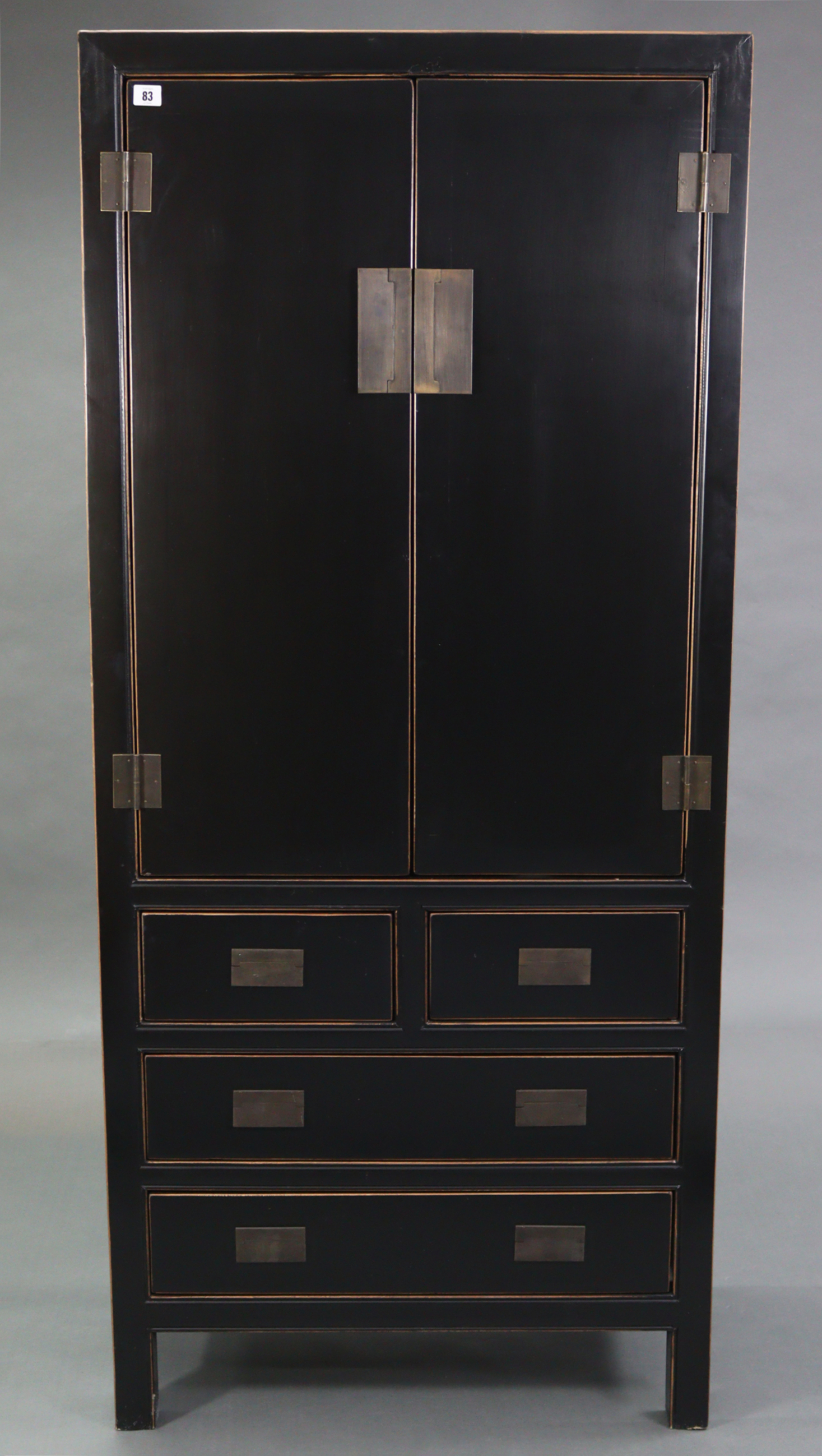 A Chinese style black & gold lacquered wardrobe, enclosed by pair of panel doors above two short & - Image 2 of 7