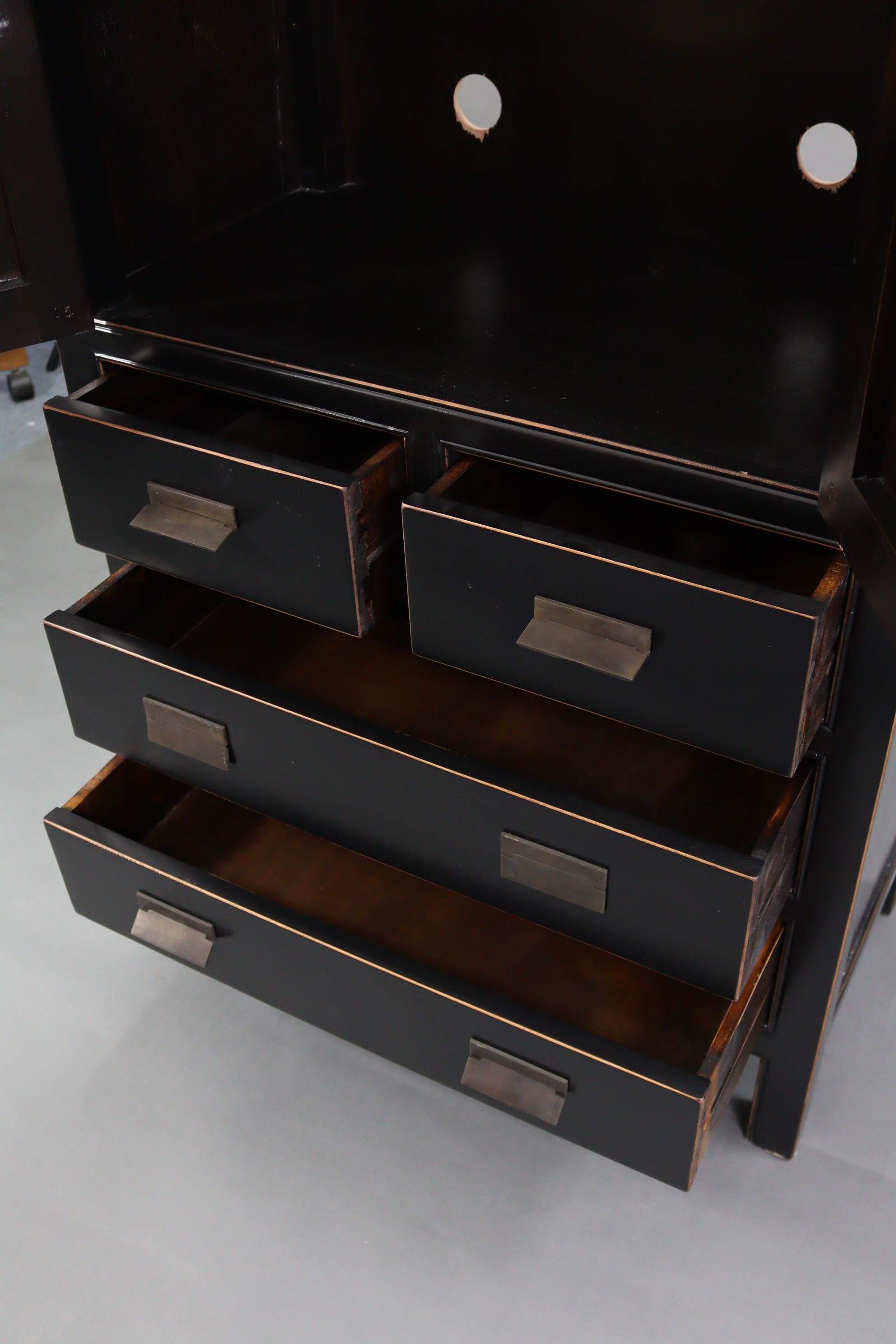 A Chinese style black & gold lacquered wardrobe, enclosed by pair of panel doors above two short & - Image 6 of 7