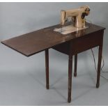 A Singer electric-operated sewing machine, w.o. in oak cabinet on four square tapered legs, “ wide.