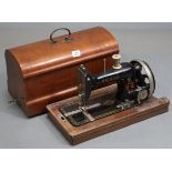 A mid-20th century Vesta hand-sewing machine, with mahogany case.
