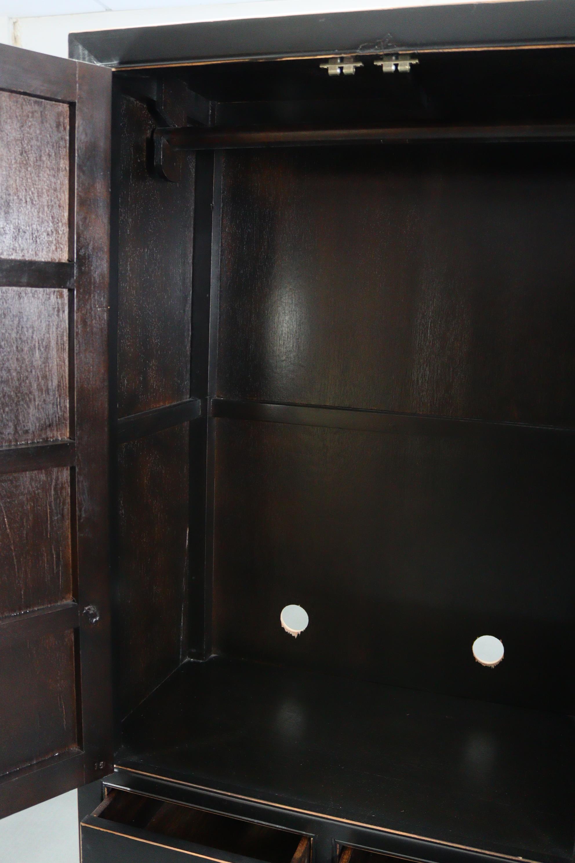 A Chinese style black & gold lacquered wardrobe, enclosed by pair of panel doors above two short & - Image 5 of 7