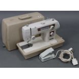 A New Home electric sewing machine with case, w.o.