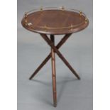 A mahogany gypsy table, with brass gallery to the circular top & on three faux-bamboo legs, 20”