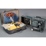 An Elf film projector, with case; together with various accessories, films, etc.