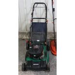 A Qualcast petrol-driven lawnmower with a Briggs & Stratton 625 series engine, & with grass box.