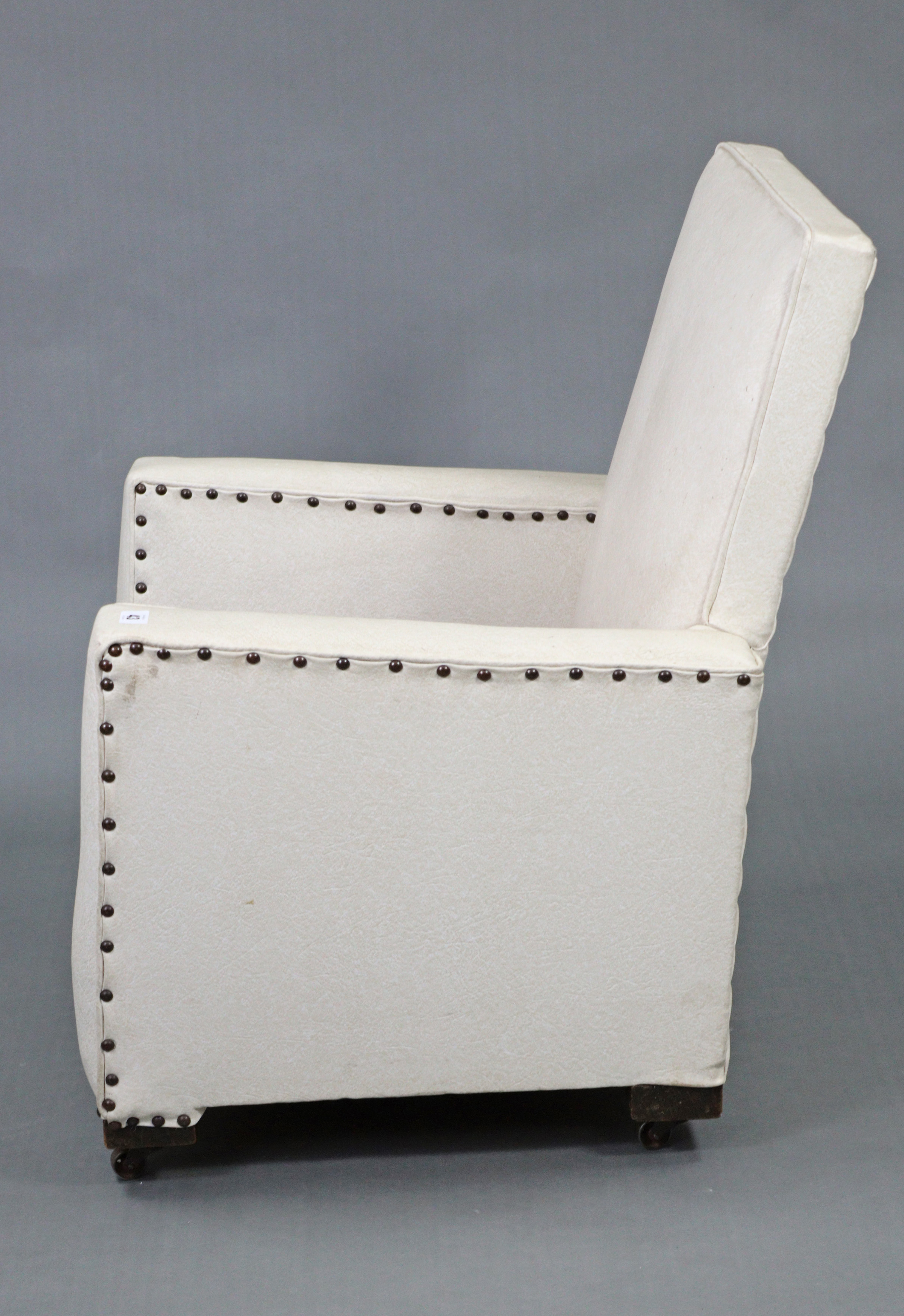 A mid-20th century square-back child’s easy chair upholstered cream rexine, & on castors. - Image 3 of 4