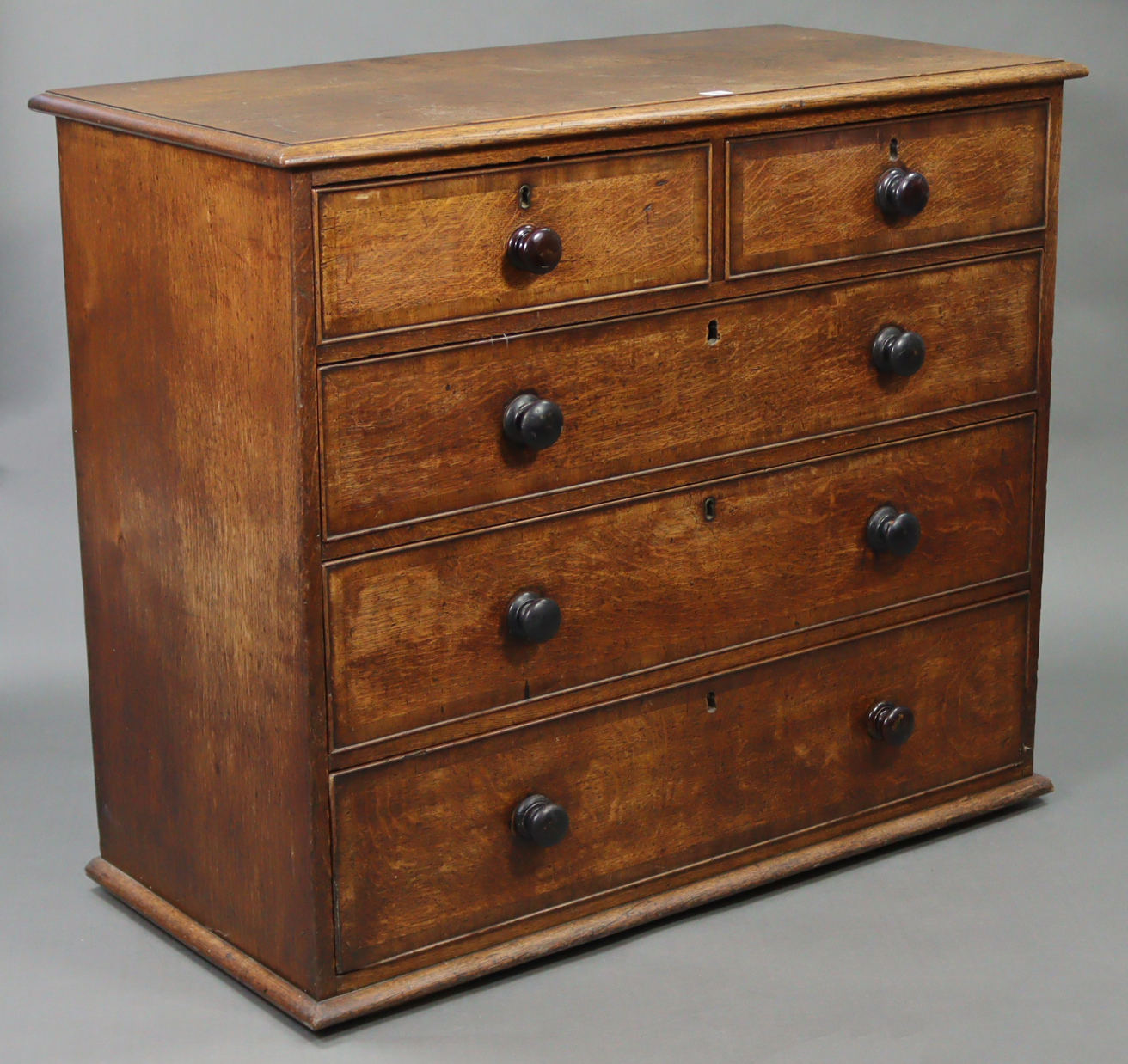 A 19th century oak chest fitted two short & three long graduated drawers with ebonised turned knob