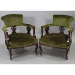 A pair of late Victorian beech-frame tub-shaped chairs with padded seats, backs & arms upholstered