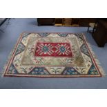 A Turkish small carpet of crimson, blue & ivory ground, with repeating geometric design to centre