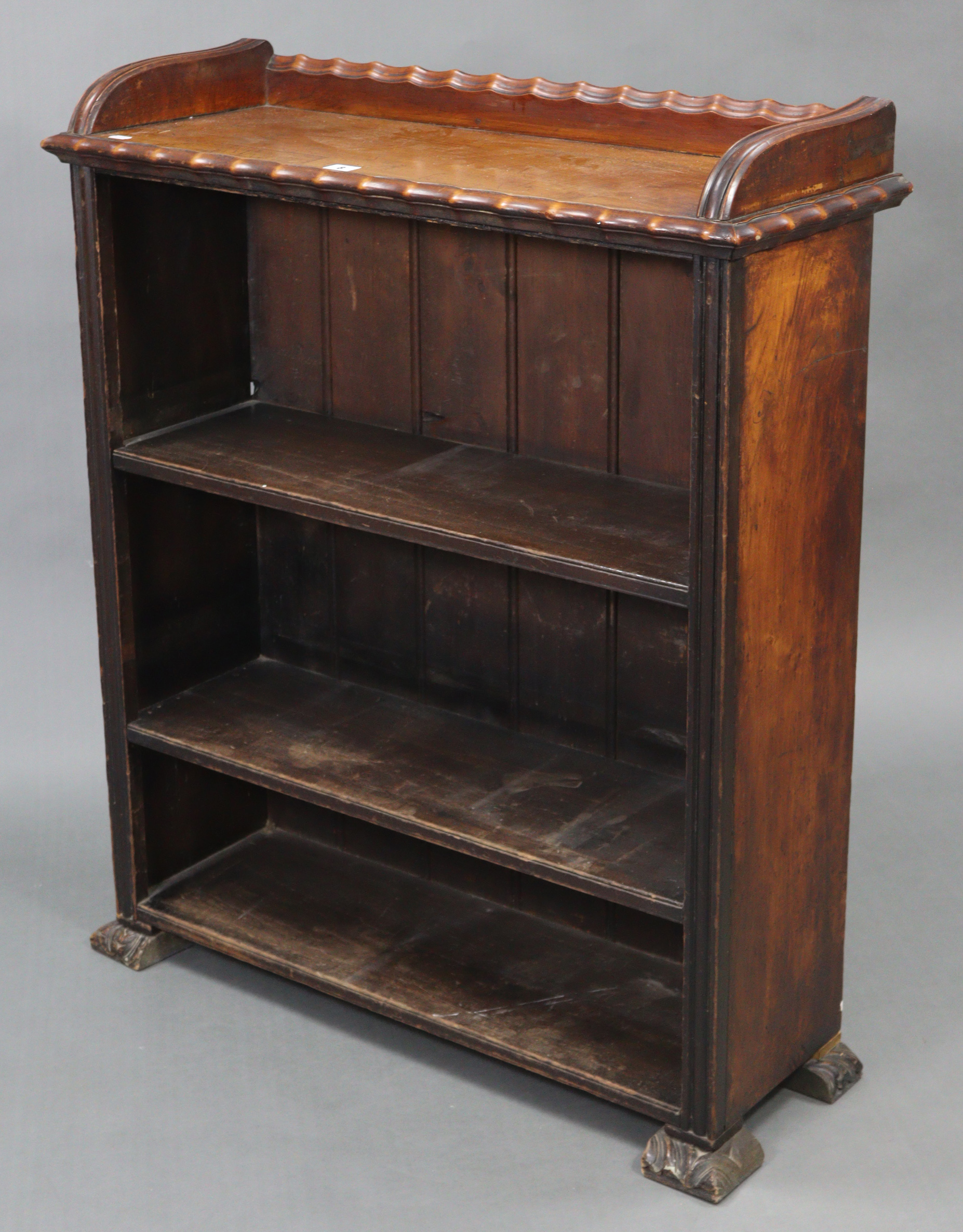 A Victorian walnut tray-top three-tier standing open bookcase, on carved block feet, 33” wide x