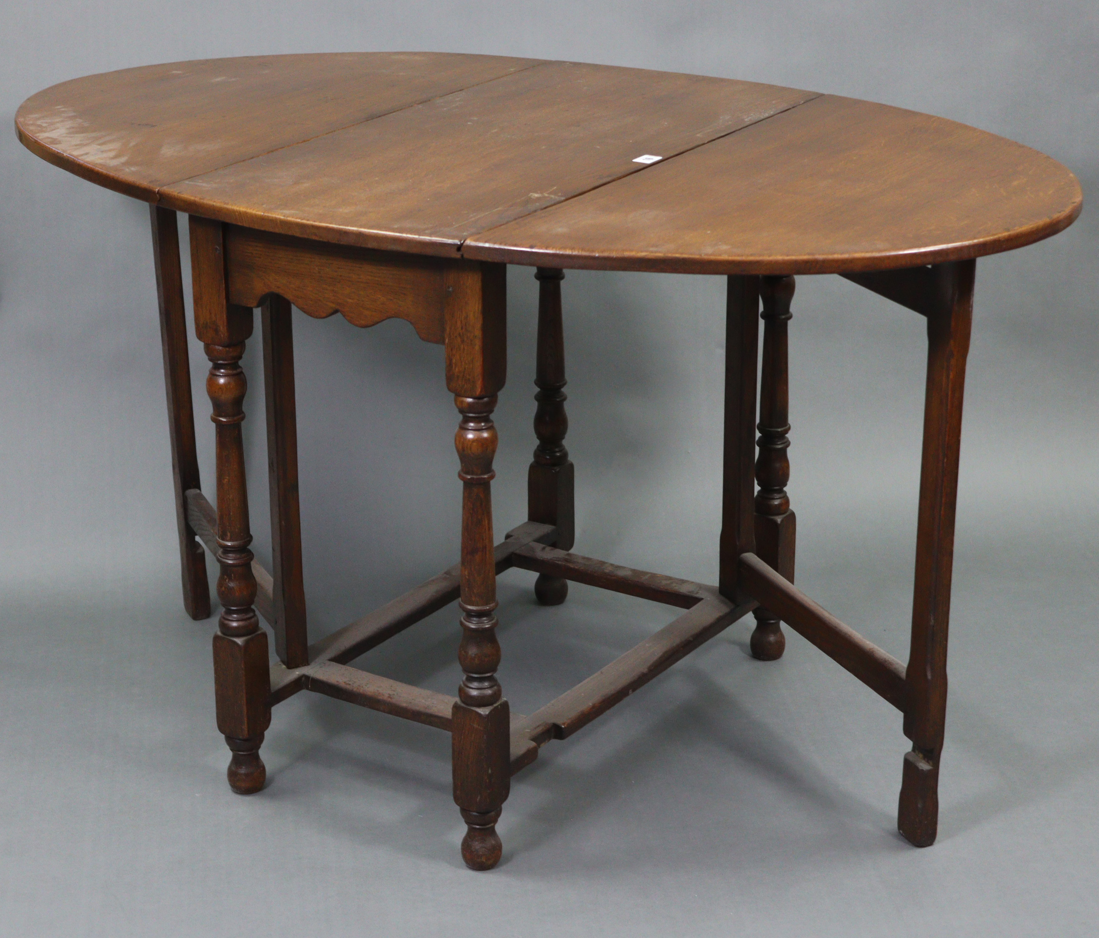 An oak oval gate-leg dining table on baluster-turned legs & turned feet with plain stretchers, 33” x - Image 2 of 3