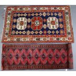 A Persian rug of deep blue, crimson & ivory ground & with geometric design to centre within a