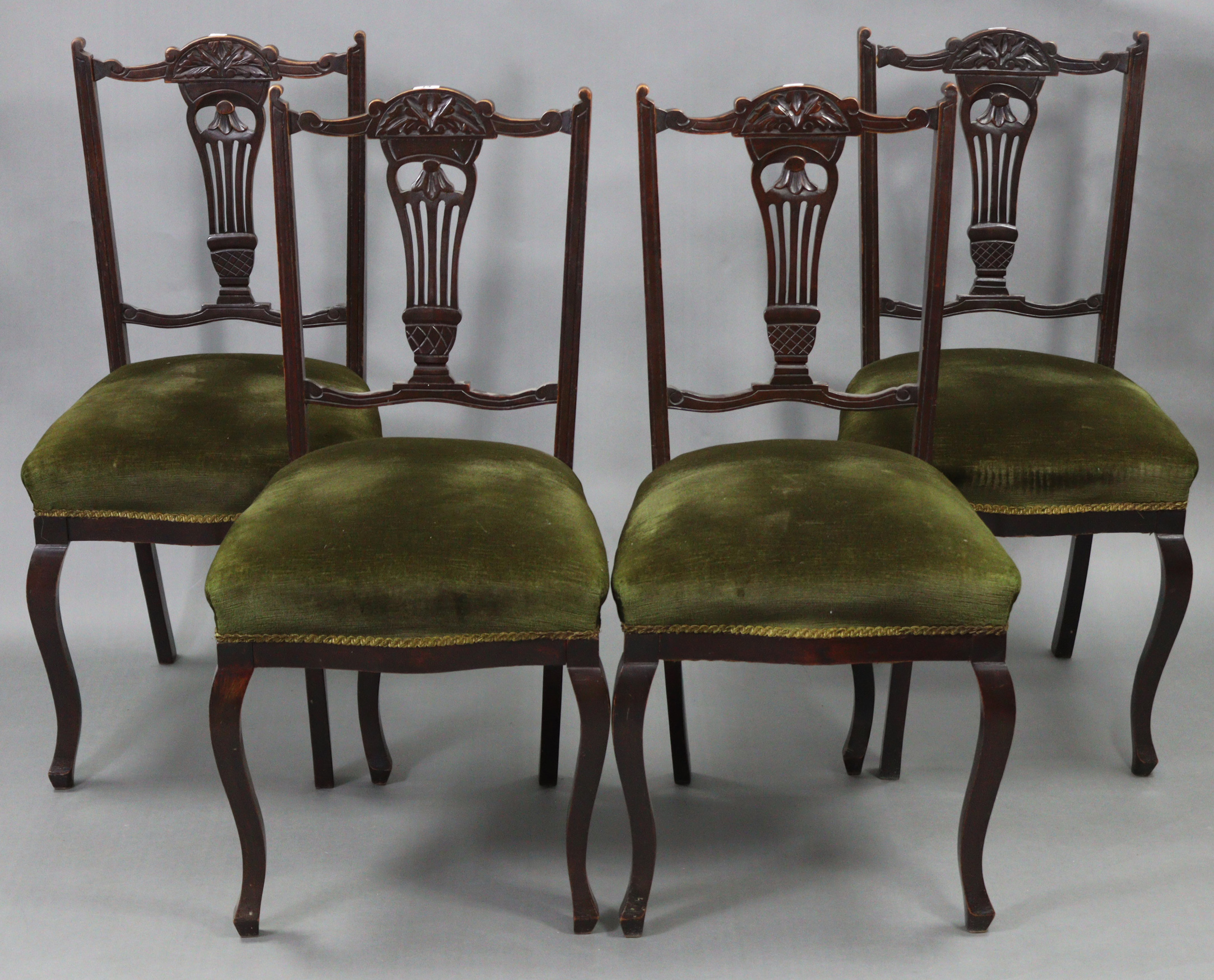 A set of four late Victorian beech splat-back dining chairs with padded seats, & on cabriole legs.