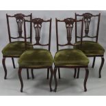A set of four late Victorian beech splat-back dining chairs with padded seats, & on cabriole legs.