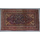 A Persian rug of blue & madder ground, with central lozenge within multiple borders; 82” x 46”; &