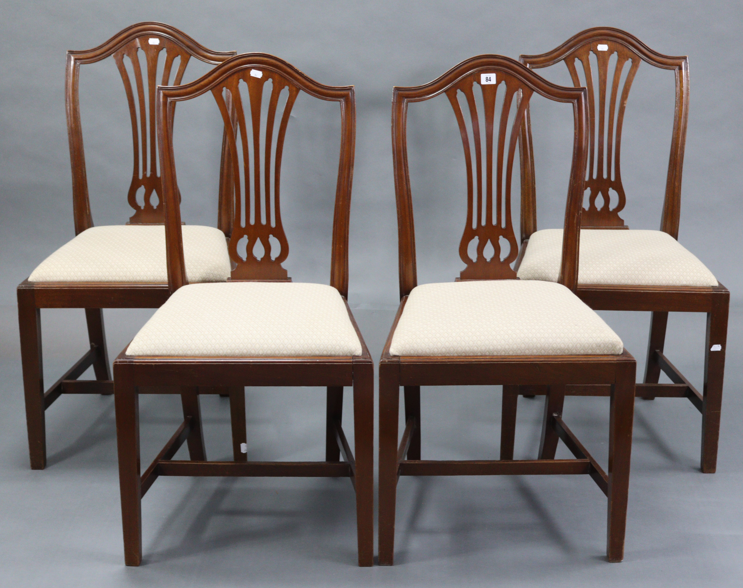 A set of four Georgian style mahogany splat-back dining chairs, with padded drop-in seats & on