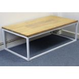 A white tubular-metal frame low rectangular coffee table on square legs & with beech top, 47½”