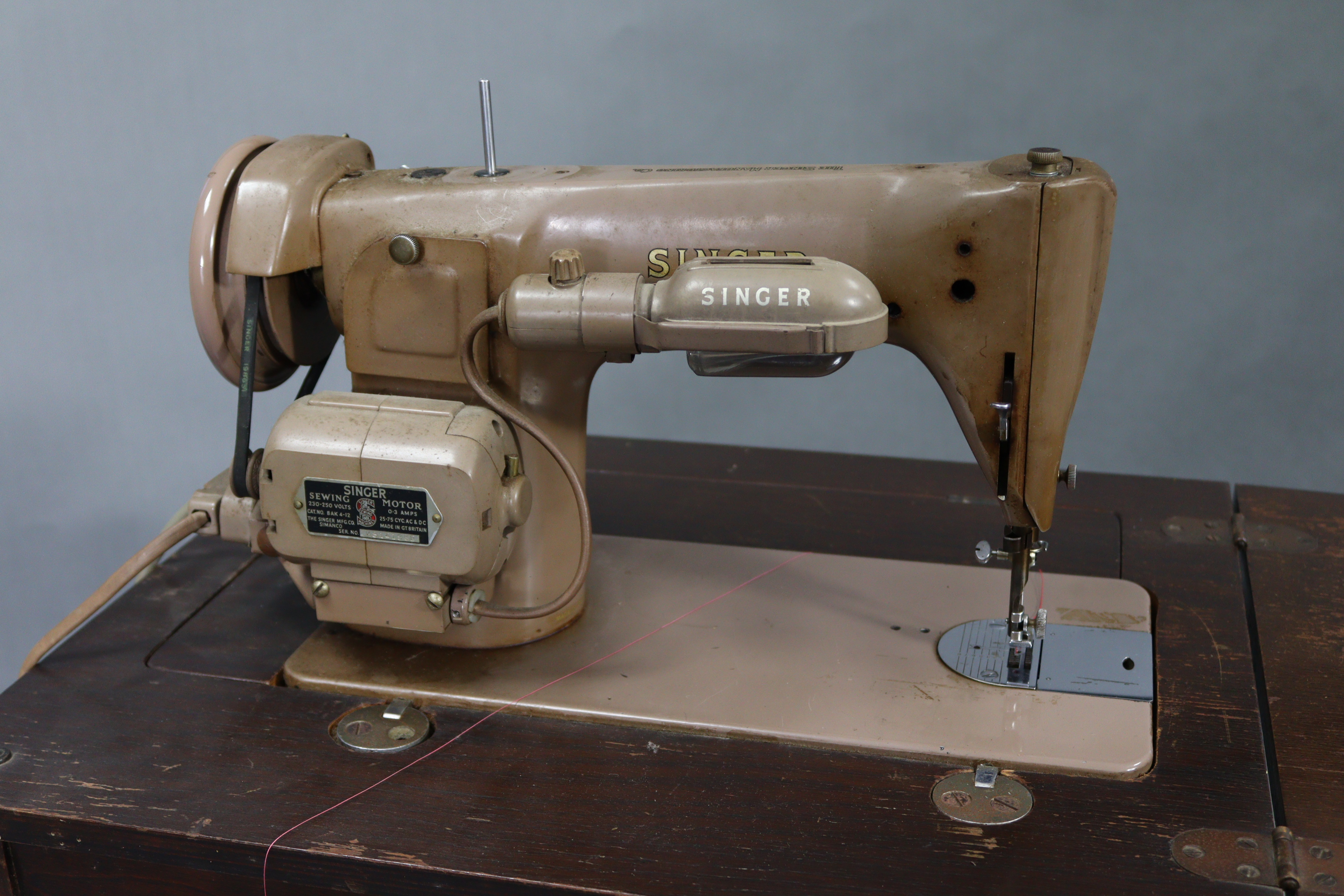 A Singer electric-operated sewing machine, w.o. in oak cabinet on four square tapered legs, “ wide. - Image 4 of 7