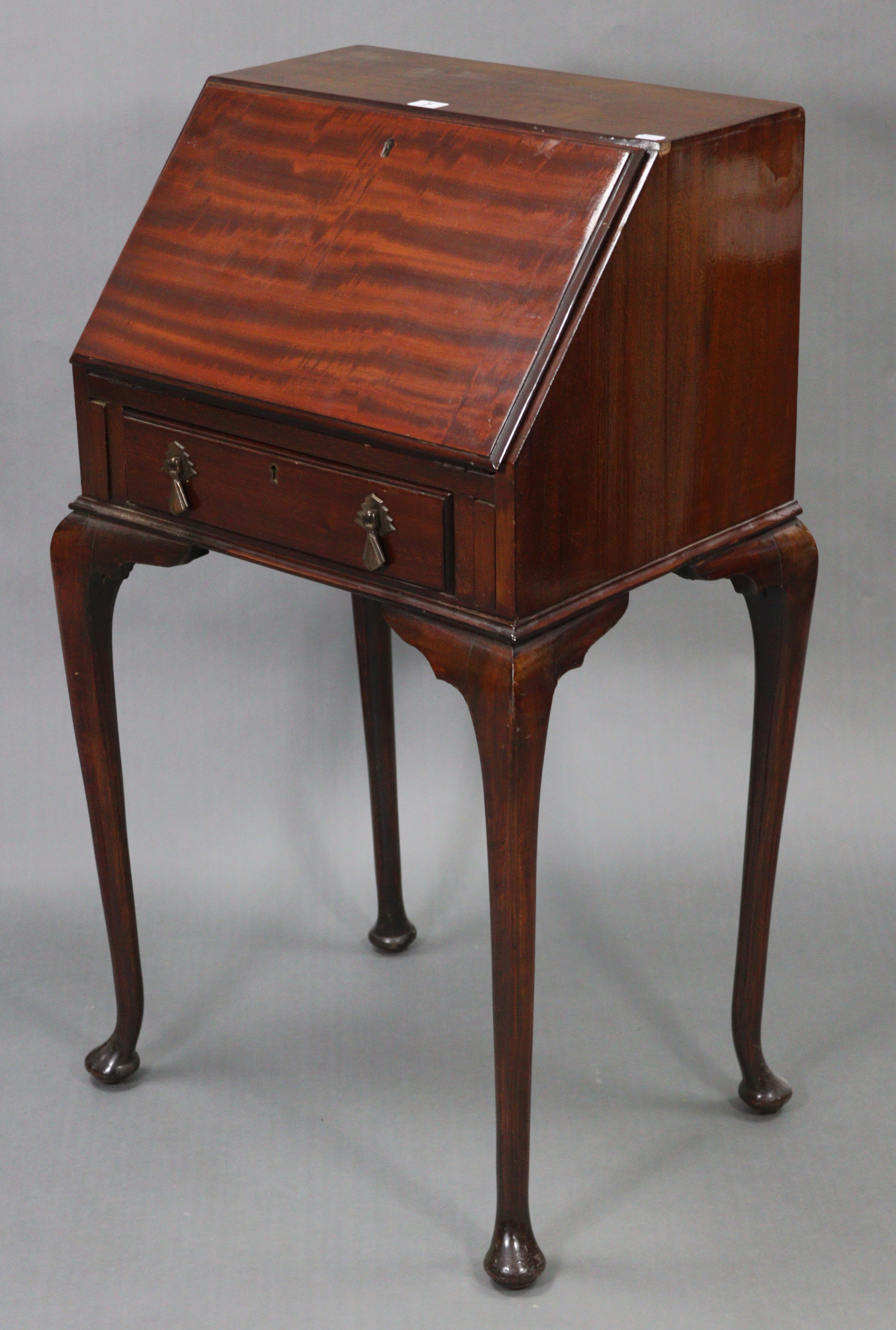 A mahogany small ladies’ bureau, with fitted interior enclosed by fall-front above a long