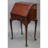 A mahogany small ladies’ bureau, with fitted interior enclosed by fall-front above a long