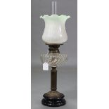 An Edwardian brass oil table lamp with clear glass reservoir & frosted-glass shade, 25” high.