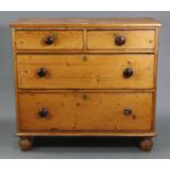 A late Victorian pine chest, fitted two short & two long graduated drawers with turned knob handles,