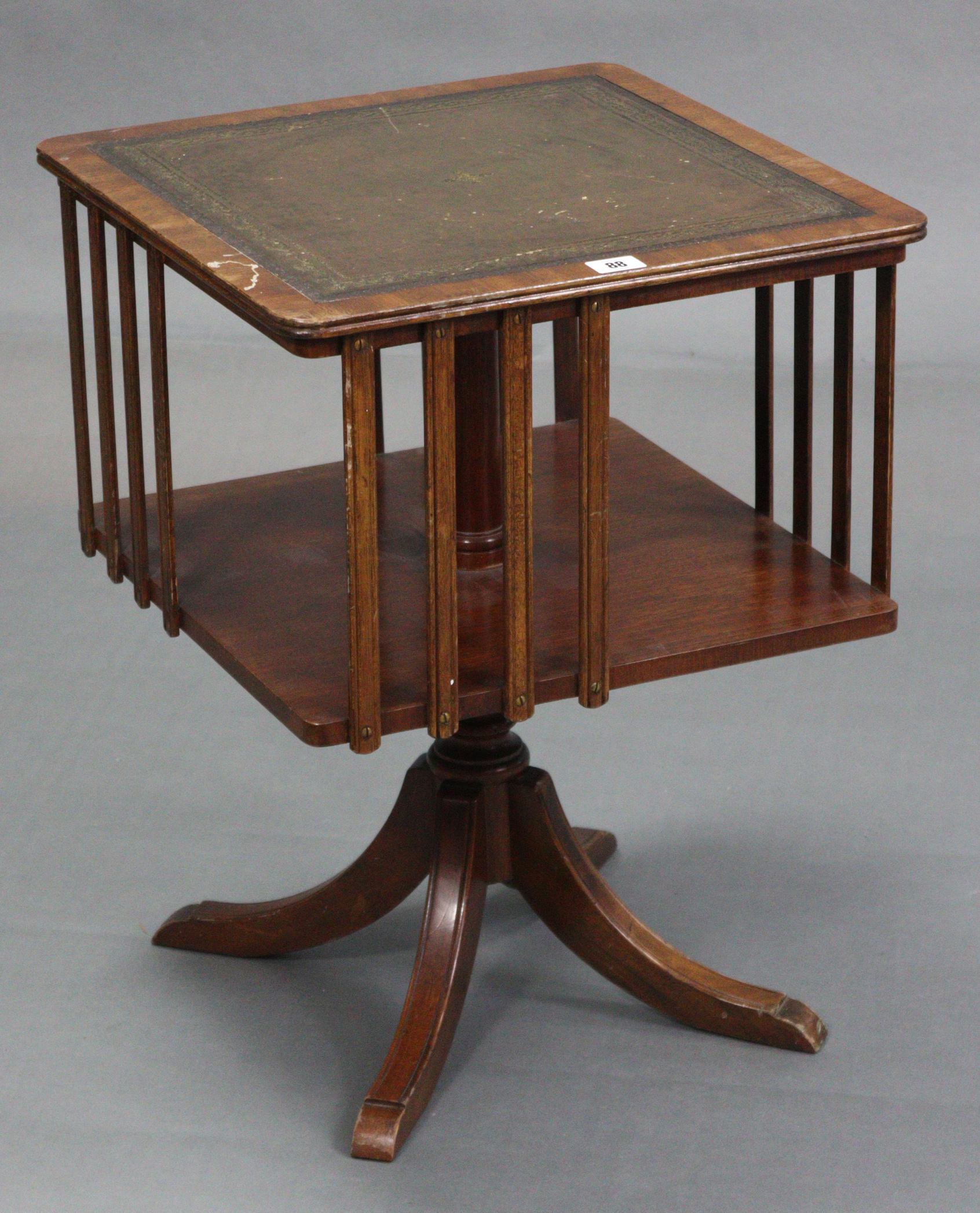 A reproduction mahogany table-top revolving bookcase inset gilt-tooled green leather, & on vase-