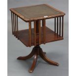A reproduction mahogany table-top revolving bookcase inset gilt-tooled green leather, & on vase-